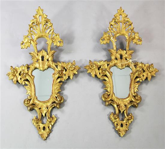 A pair of 20th century Italian carved giltwood cartouche shaped wall mirrors, 3ft 7in. x 2ft 1in.